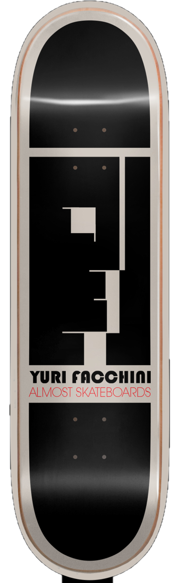 Almost Yuri Bauhaus Impact Pro Light 8.375 skateboard deck: Black deck with a cream-coloured border and a blocky geometric profile head in black and cream, in the style of a Bauhaus poster. Rider name and brand printed beneath in cream and red.