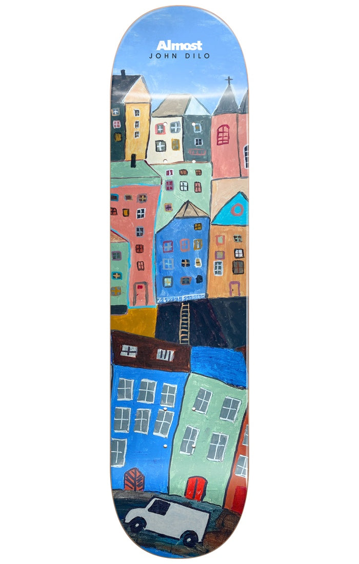 Almost Dilo Places R7 RIGHT 8.375 skateboard deck: Naive painting of a steep hillside town of tall colourful houses with small windows and church spires under a blue sky, with a white van at the bottom. Almost logo and rider name at the nose.