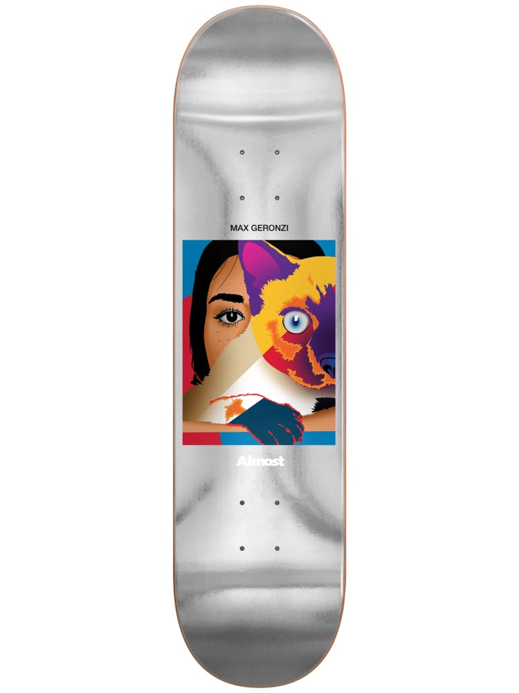Almost Max Life Stills Impact Light 8.25 skateboard deck: Framed graphic illustration of a woman's face merging with a colourful wolf or fox head, in blue, orange, purple and pink, on a silver foil deck. Max Geronzi above and Almost below the picture.