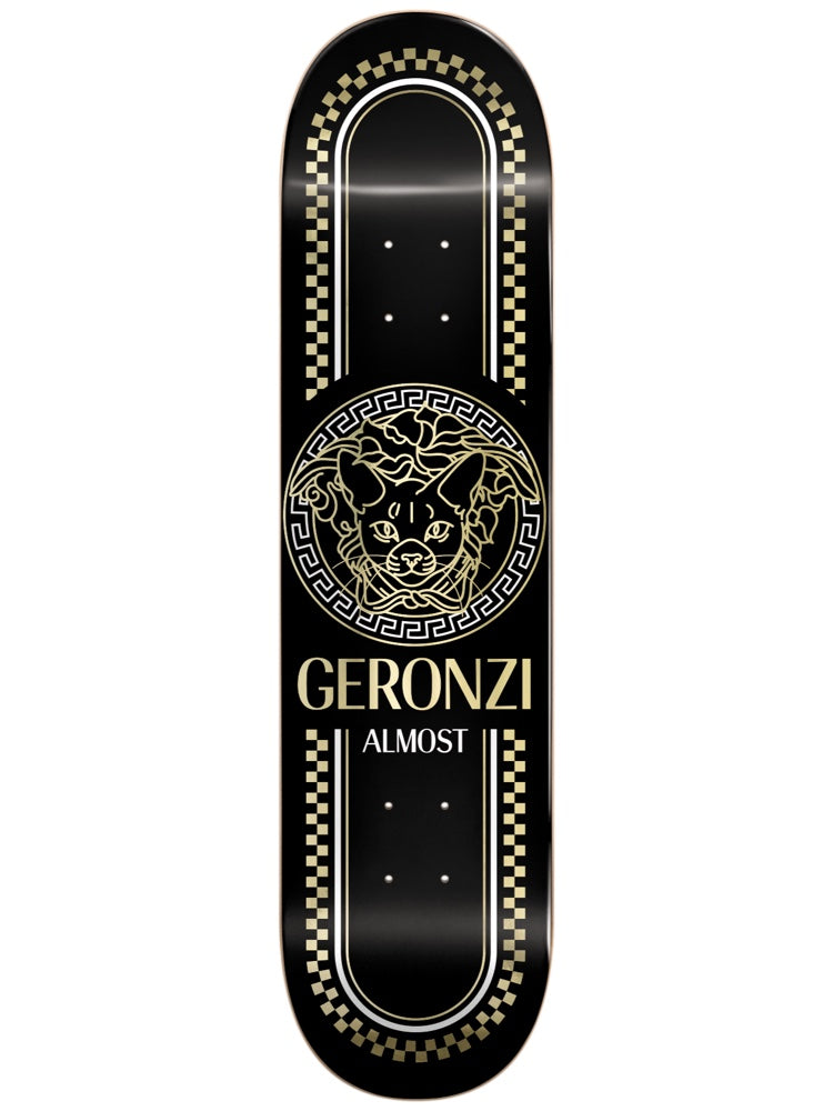 Almost Max Luxury Super Sap R7 8.5 skateboard deck: Gold line-art cat's head inside a Greek-key medallion in the style of a luxury fashion logo, with gold chequered borders on a black deck, and rider name and brand in gold below.
