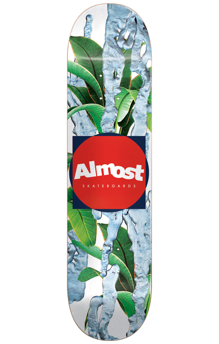 Almost Metal HYB 8.375 skateboard deck: Large green banana-style leaves on a white ground, overlaid with dripping, molten-looking silver-blue metallic streaks. A navy square with a red circle sits in the centre, holding the white Almost logo.