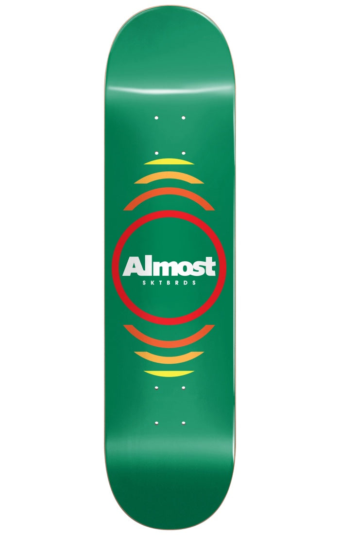 Almost Reflex Youth GREEN 7.375 MID skateboard deck: A red ring around a white Almost SKTBRDS logo, with concentric arcs fading from red through orange to yellow above and below, on a plain green deck.