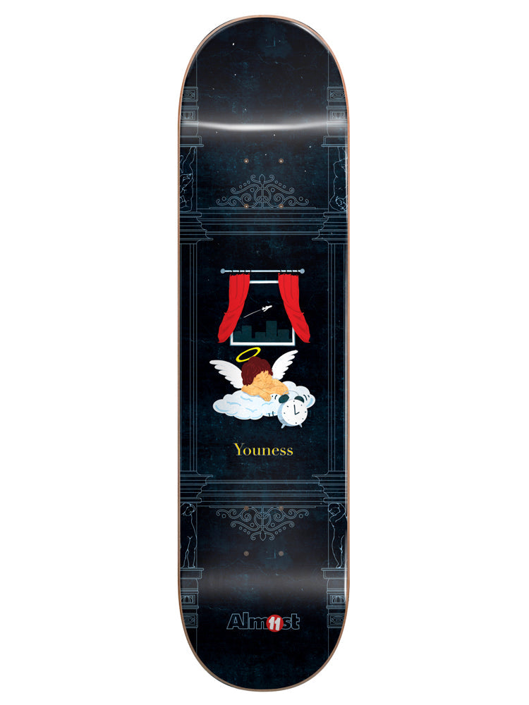 Almost Youness Gronze Collab R7 8.0 skateboard deck: Small winged cherub with a halo asleep on a cloud beside an alarm clock, beneath a window with red curtains showing a night skyline and a plane. Set within a classical ornamental frame on a dark navy ground.