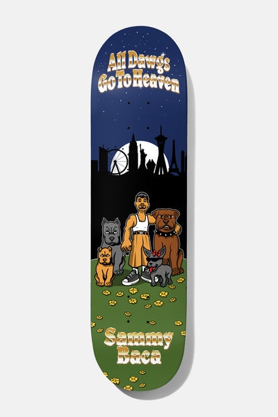 Baker Baca All Dawgs Go To Heaven 8.5 skateboard deck: Cartoon scene of a man in an orange kilt and white vest standing with four dogs on a grass field dotted with paw prints, in front of a night skyline with a Ferris wheel and landmarks under a full moon. Gold lettering at top and bottom.