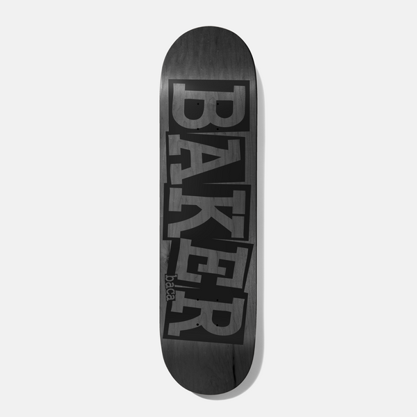 Baker Baca Ribbon Grey Veneer 8.475 skateboard deck: Large Baker ribbon logo with stacked, cut-and-pasted style letters printed in black over a grey stained veneer, with the rider name Baca in small lettering at the lower left.