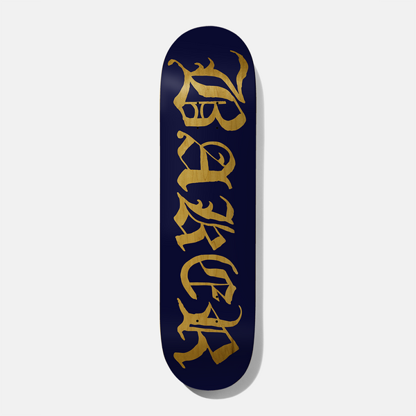 Baker Figgy Old E Navy/Yellow Veneer 8.25 skateboard deck: Navy blue deck with the Baker name in large old English blackletter, in yellow wood veneer showing through, running down its length.