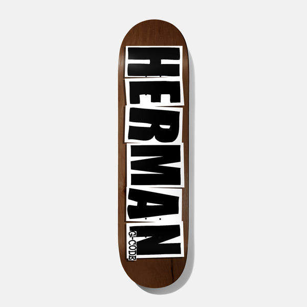 Baker Herman Logo Brown 8.25 skateboard deck: Rider surname HERMAN in huge black capitals, each letter on its own white cut-out block, running the length of a brown stained deck. Small G-Code label at the bottom.