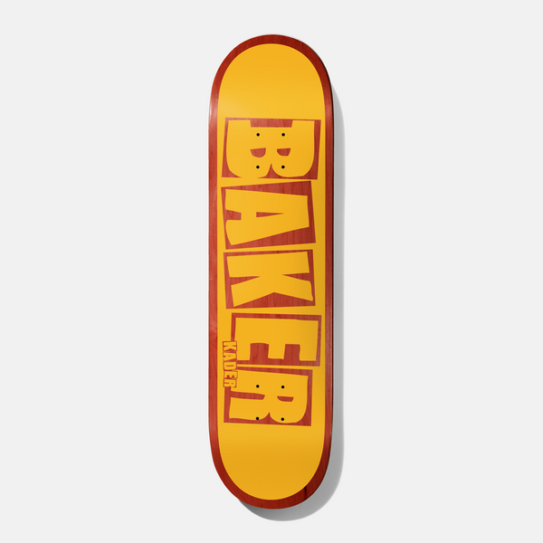 Baker Kader Brand Name Yellow/Red 7.875 skateboard deck: The Baker name is stacked vertically in chunky, roughly cut capital letters in yellow, with red wood-grain showing through the letters. A red border frames the yellow ground, with the rider's name in small type beside the E.