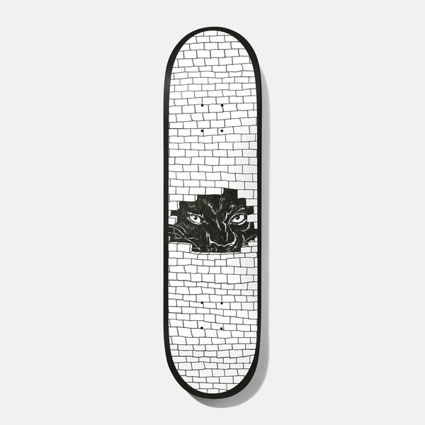 Baker Kader Frenz 8.25 skateboard deck: White brick wall drawn in black line with a broken hole through which a black panther-like animal's glaring eyes can be seen, with a black edge around the deck.