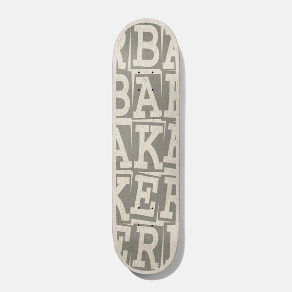 Baker Kader Ribbon Stack 8.0 B2 skateboard deck: Baker name in large cream serif letters stacked and overlapping in rows across the whole deck, over a grey, paper-like texture.