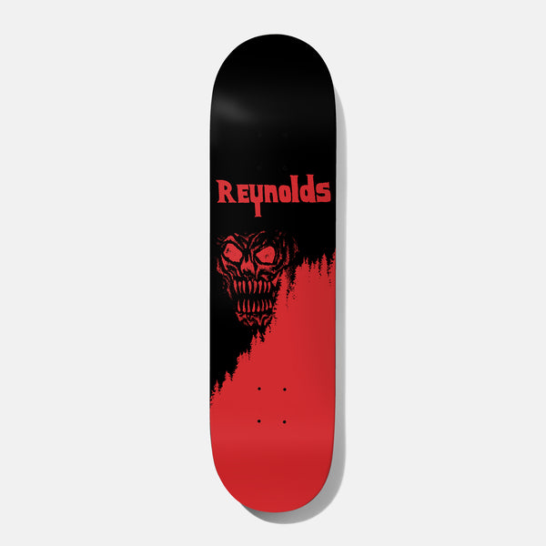 Baker Reynolds Forest Terror 8.25 skateboard deck: Black deck with REYNOLDS in red horror-style lettering above a snarling red demon skull. A red pine-tree silhouette treeline rises from the bottom, filling the lower half in red.
