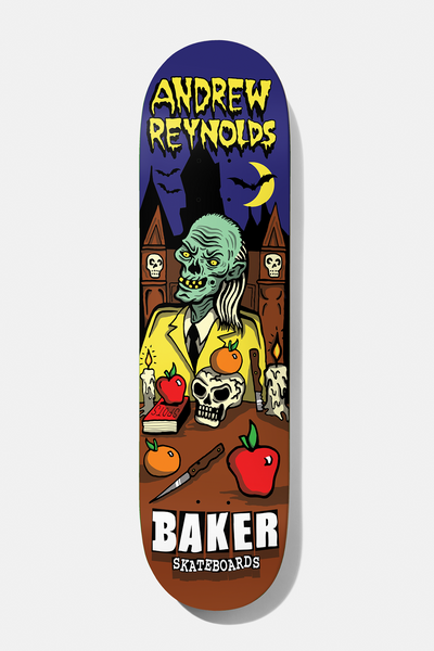 Baker Reynolds Tales From The Boss 8.25 skateboard deck: Cartoon horror scene of a green zombie in a yellow suit seated at a table with a skull, candles, apples, oranges and a knife, before a spooky castle under a crescent moon with bats, with Andrew Reynolds in dripping yellow lettering.