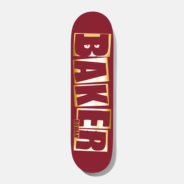 Baker Rowan Brand Name Red/Foil B2 8.38 skateboard deck: Baker logo in large capital letters with gold foil outlines on a deep red deck, with the small word ROWAN down the side of the K and E, and eyes peeping in the B.