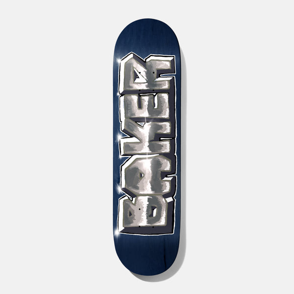 Baker Rowan Part Machine B2 8.5 skateboard deck: Chunky graffiti-style Baker lettering rendered in shiny chrome with white and black outlines and glints, running down the length of a navy blue stained deck.
