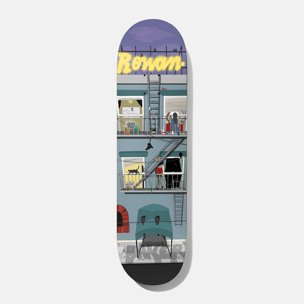 Baker Rowan Pigeon View 8.38 skateboard deck: Flat illustration of a city apartment block with fire escapes, residents in windows, a cat, hanging shoes and an awning, under a purple sky with a yellow neon sign style name on the roof. Grey painted brand lettering sits at street level.