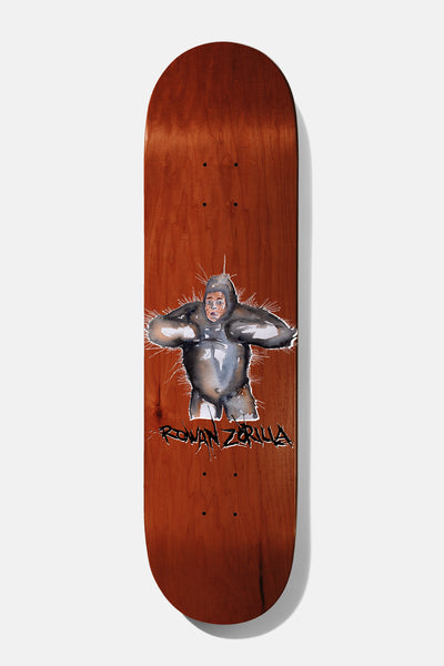 Baker Rowan Shep Dawgs 4 8.125 skateboard deck: Painted-style illustration of a grey gorilla with its arms raised to its head, wearing a human-like face and a pale loincloth, on a red-brown stained deck. The rider's name is scrawled in black below.