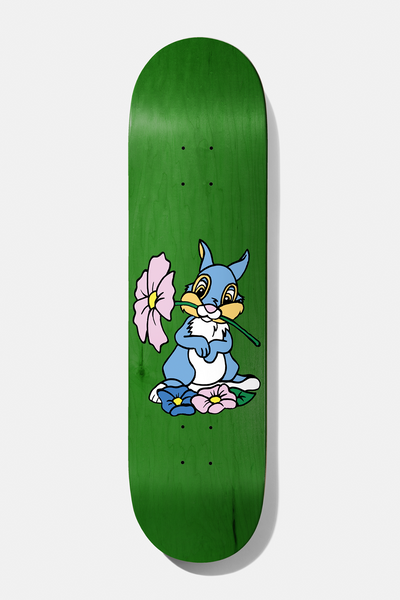 Baker Sully Little April Shower 8.5 skateboard deck: Green stained deck with a cartoon blue rabbit holding a large pink flower in its mouth, surrounded by smaller pink and blue flowers.