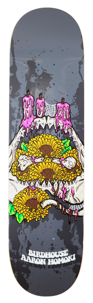 Birdhouse Aaron Jaws Homoki Shrine skateboard deck: Shrine of yellow sunflowers and skulls laid in a pair of open jaws, topped with pink dripping candles, on a grey splattered background. Birdhouse and the rider's name in cream lettering below.