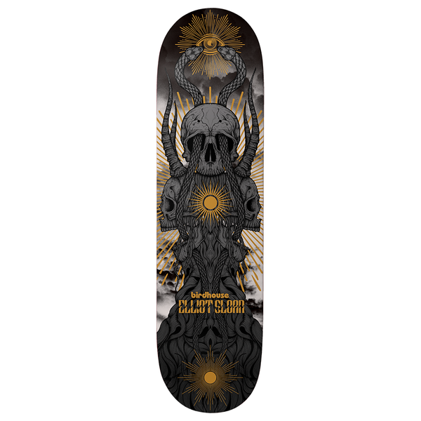 Birdhouse Elliot Sloan Provan 8.38 skateboard deck: A stack of grey horned skulls entwined with snakes and roots, topped by a winged eye and golden sunbursts, against a cloudy sky on a dark deck. Rider name in gold lettering near the tail.