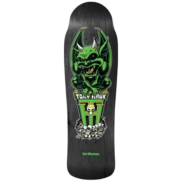 Birdhouse Gargoyle 9.75 skateboard deck: Green horned gargoyle crouching on a pedestal carrying the rider name and a large H emblem with a small skull, above a pile of skulls, on a black stained old-school shaped deck.