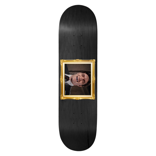 Birdhouse Jaws Golden Fried 8.25 skateboard deck: Black stained deck with a gold ornate picture frame in the centre, containing a photo of a smiling man in a suit wearing a metal grill over his teeth.