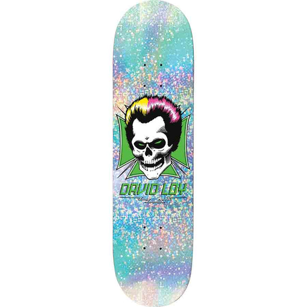 Birdhouse Loy Skull Prism 8.38 skateboard deck: A grinning skull with a quiffed black, yellow and pink pompadour sits in front of a green Maltese cross, with David Loy in green lettering and lightning bolts below, on a holographic glitter deck in pastel blue.