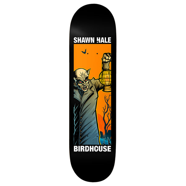 Birdhouse Shawn Hale Second Life 9.0 skateboard deck: A pale vampire in a long grey coat, with red eyes and fangs, holds up a glowing lantern against an orange sky with bats and bare trees, inside a rectangular panel on a black deck. Rider and brand names above and below.
