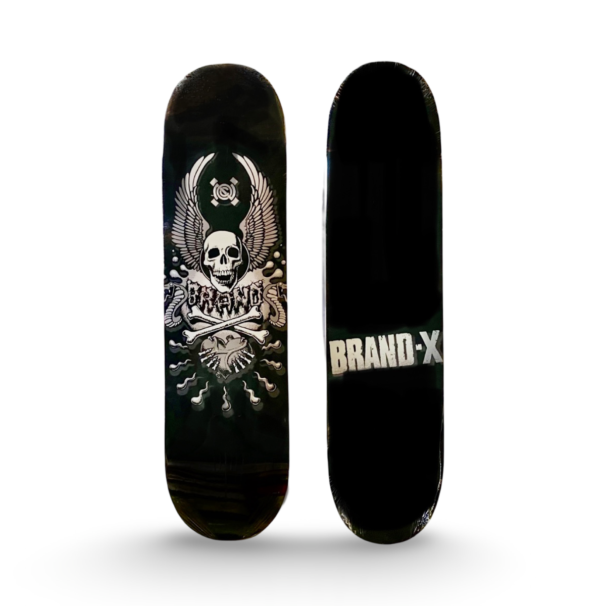 Brand-X X-Con Blackout skateboard deck: A winged skull above crossed bones in white and grey on a black deck, with Brand-X in drippy lettering across the bones and a circular emblem above the skull. The underside shows the Brand-X name in white block text.