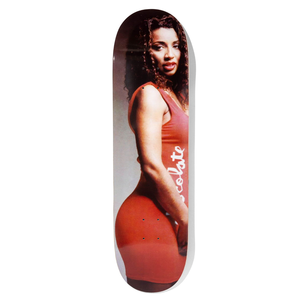 Chocolate Aikens Carls Mom skateboard deck: Full-deck colour photograph of a woman with long curly dark hair in a tight red dress with 'Chocolate' written in white script down the side, posed side-on against a grey backdrop.