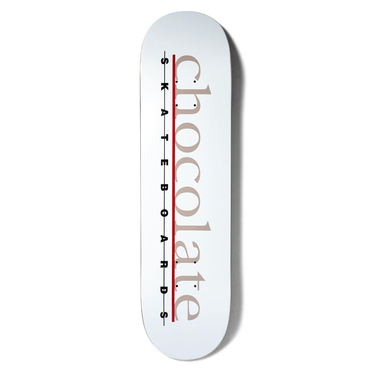 Chocolate Anderson Bar Logo skateboard deck: White deck with the word chocolate in large taupe serif lowercase letters down the length, crossed by a red line, with spaced black SKATEBOARDS lettering alongside.