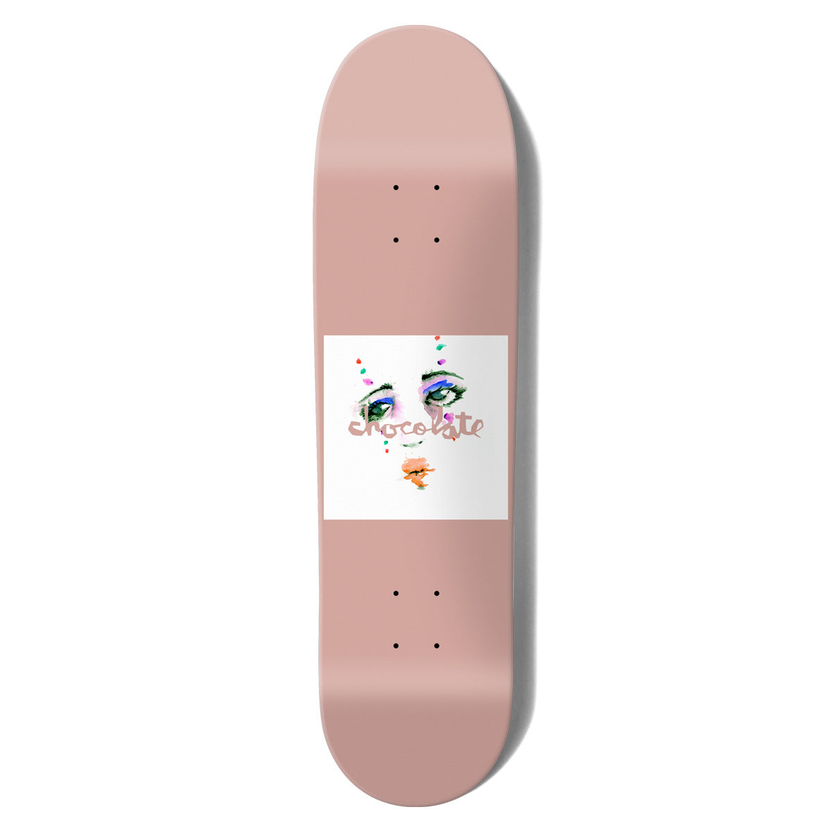 Chocolate Anderson Dream Rodeo Skidul skateboard deck: Plain dusty pink deck with a white square in the centre showing a painted woman's face, with only eyes and mouth visible, and dots of colour. Chocolate logo in pink script across it.