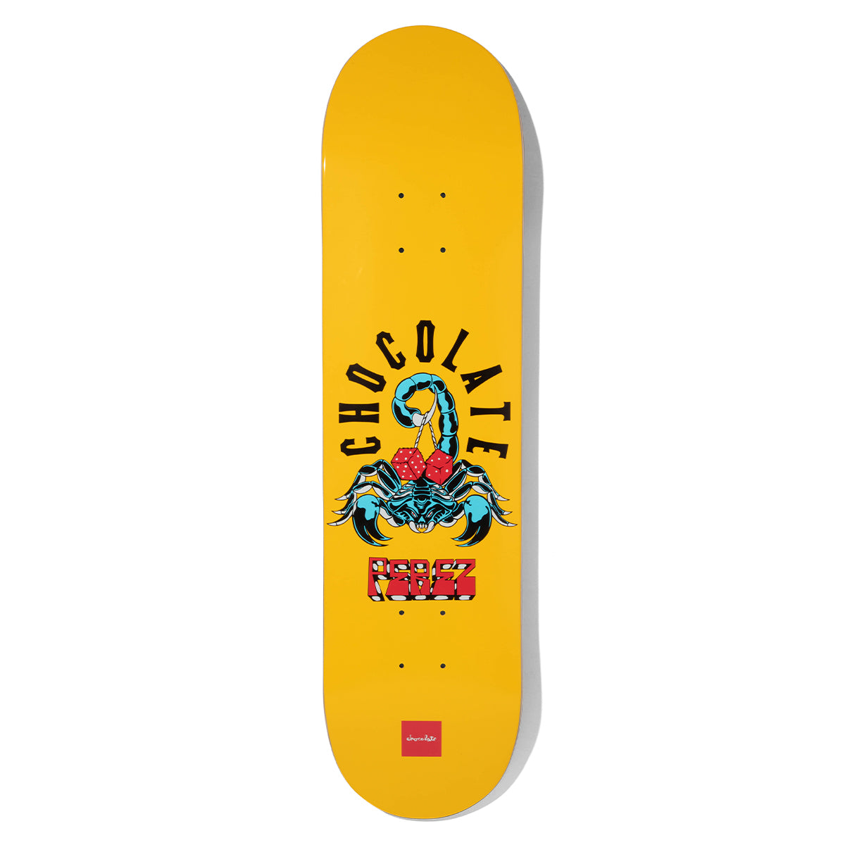 Chocolate Perez Scorpion Dice skateboard deck: A blue scorpion holding a pair of red dice in its tail sits beneath arched Chocolate lettering, with Perez in red block letters below, on a plain yellow deck with a small red Chocolate logo at the tail.