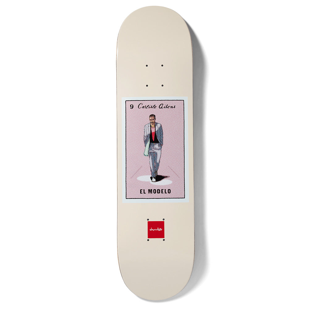Chocolate Aikens Loteria skateboard deck: Cream deck with a lotería card in the centre: a man in a grey suit and green scarf walking in a spotlight on a pink background, captioned El Modelo and numbered 9. Chocolate logo below.