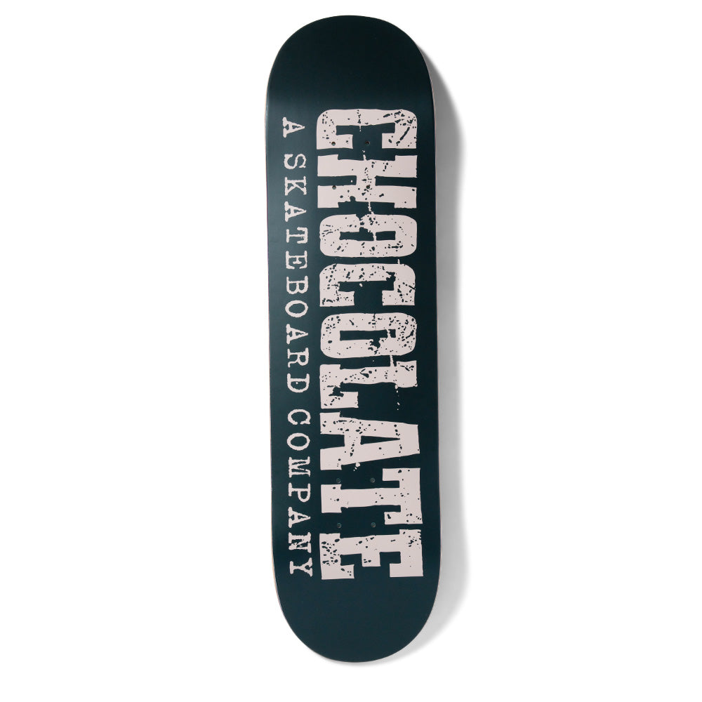 Chocolate Anderson Western skateboard deck: Large distressed Western-style slab lettering spelling Chocolate runs the length of a dark teal deck, with 'A Skateboard Company' in smaller type alongside, all in pale pink.