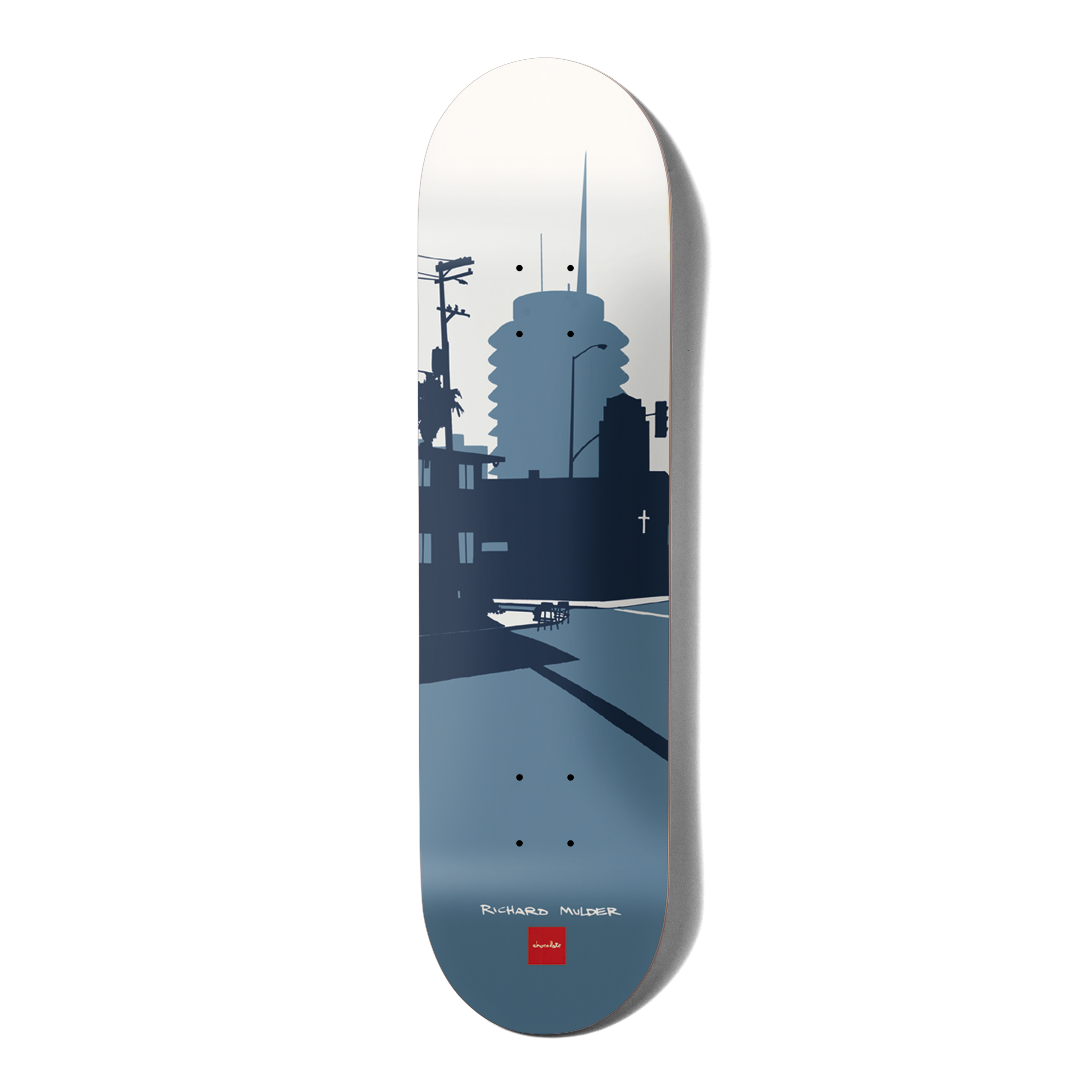 Chocolate Mulder Original City skateboard deck: Flat blue-grey silhouette illustration of a Los Angeles street scene with a round tower, telephone pole, palm tree and shadows, fading from white sky to slate blue. Rider name and Chocolate logo at the tail.