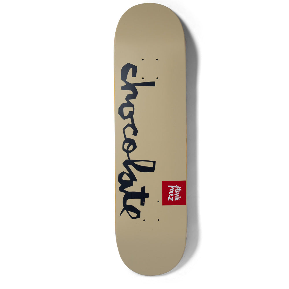 Chocolate Perez Team Chunk skateboard deck: Plain tan deck with the Chocolate handwritten script logo in navy running down its length and a small red Chocolate label with the rider's name near the tail.