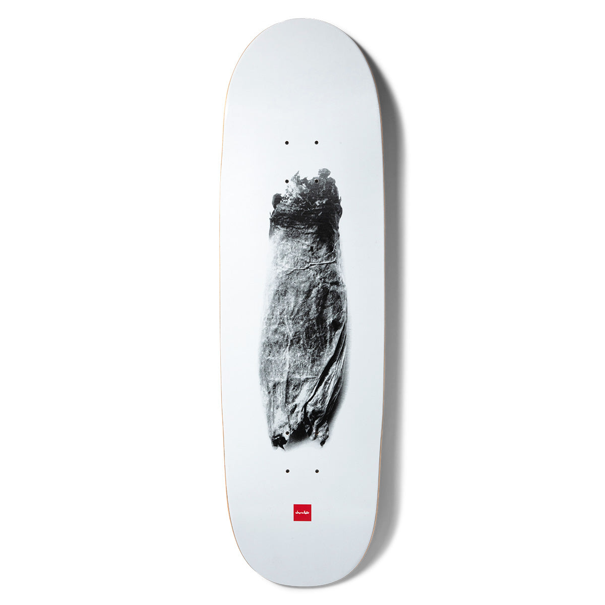 Chocolate Tershy Zorched Couch skateboard deck: Grainy black and white photograph of a scorched, charred couch or armchair shape centred on a plain white deck, with the small red Chocolate logo near the tail.