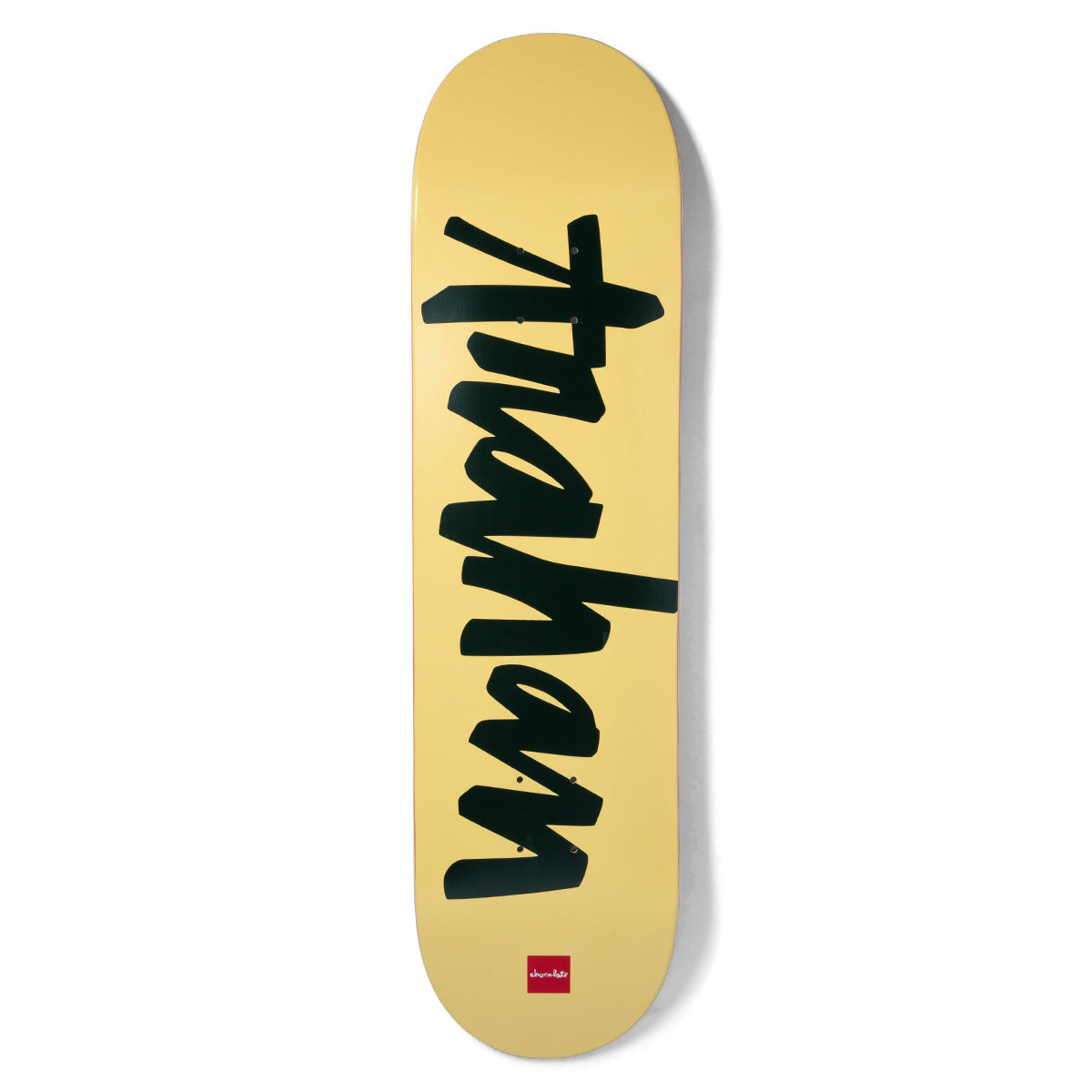 Chocolate Trahan OG Chunk skateboard deck: Rider's name 'trahan' in large black brush-script lettering running up the deck on a pale yellow background.