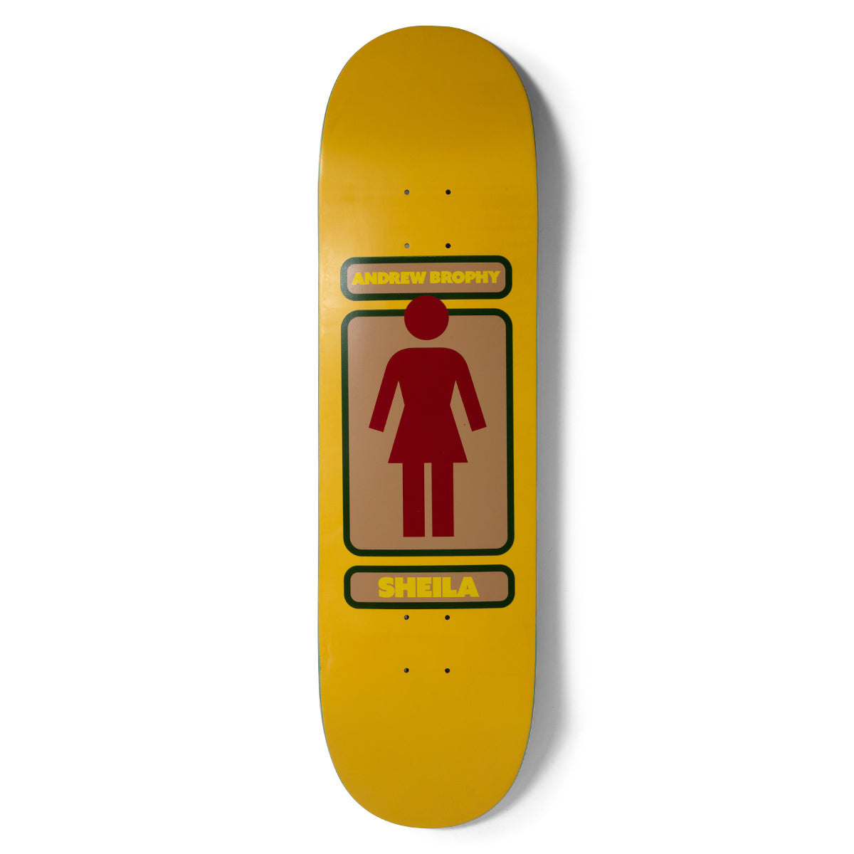 Girl Brophy 93 Til skateboard deck: Girl's standing figure logo in dark red inside a tan rectangle with green border, with 'ANDREW BROPHY' above and 'SHEILA' below in yellow panels, on a mustard yellow deck.