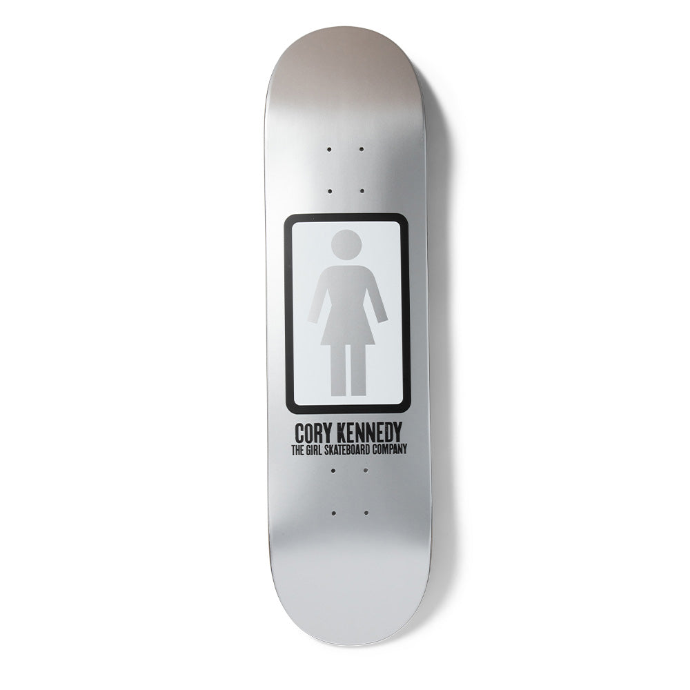 Girl Kennedy OG Black & White skateboard deck: Metallic silver deck with the Girl logo, a white female figure in a black rounded rectangle, with the rider name and company name in black capitals underneath.