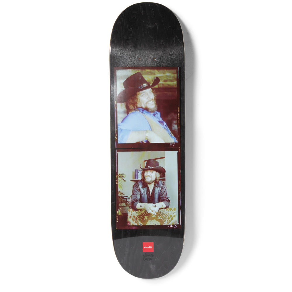Chocolate Waylon Capps skateboard deck: Two vintage colour contact-sheet photographs of a bearded man in a black cowboy hat, one in a blue shirt and one in a leather jacket, on a black stained deck with a small red Chocolate logo.