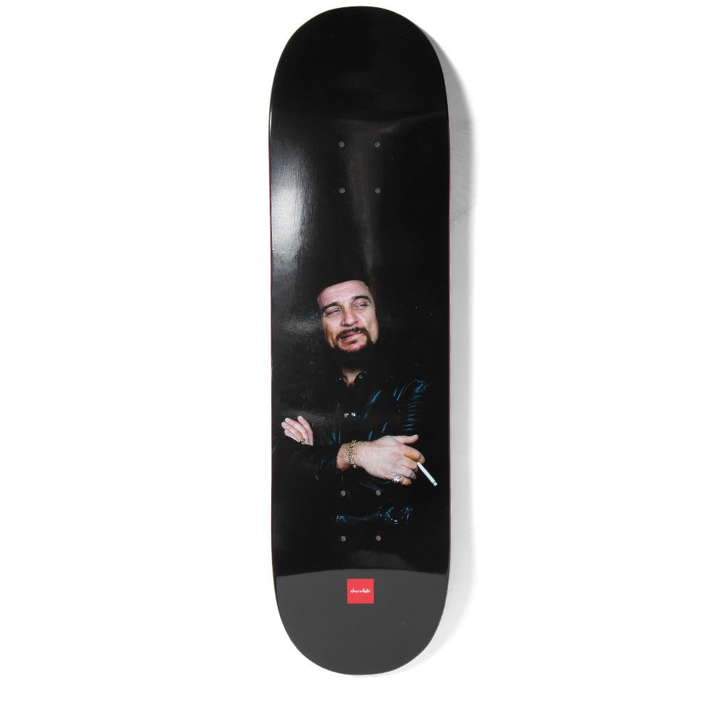 Chocolate Waylon Perez skateboard deck: Dark photographic portrait of a bearded man in a black leather jacket with arms folded, holding a cigarette, against a black background. Small red Chocolate logo at the tail.