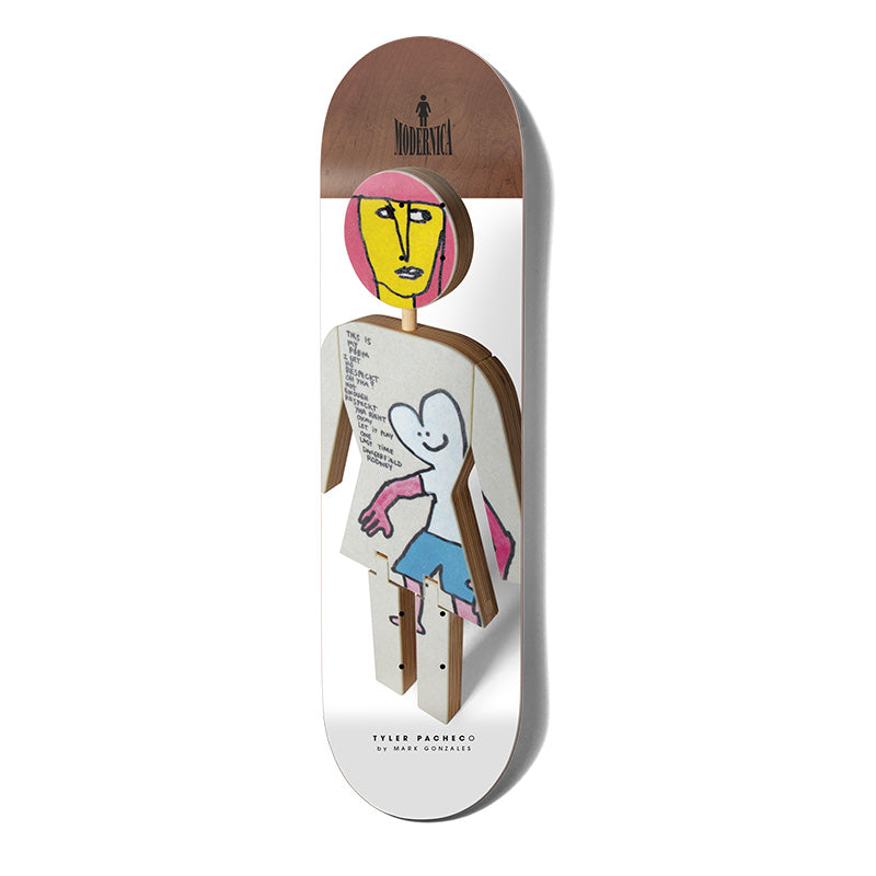 Girl Pacheco Modernica skateboard deck: A photographed three-dimensional cut-out of the Girl logo figure, made of layered wood and painted with a yellow-faced head, a smiling blue figure and handwritten text on the body. The top of the deck is brown wood veneer with a Modernica label.