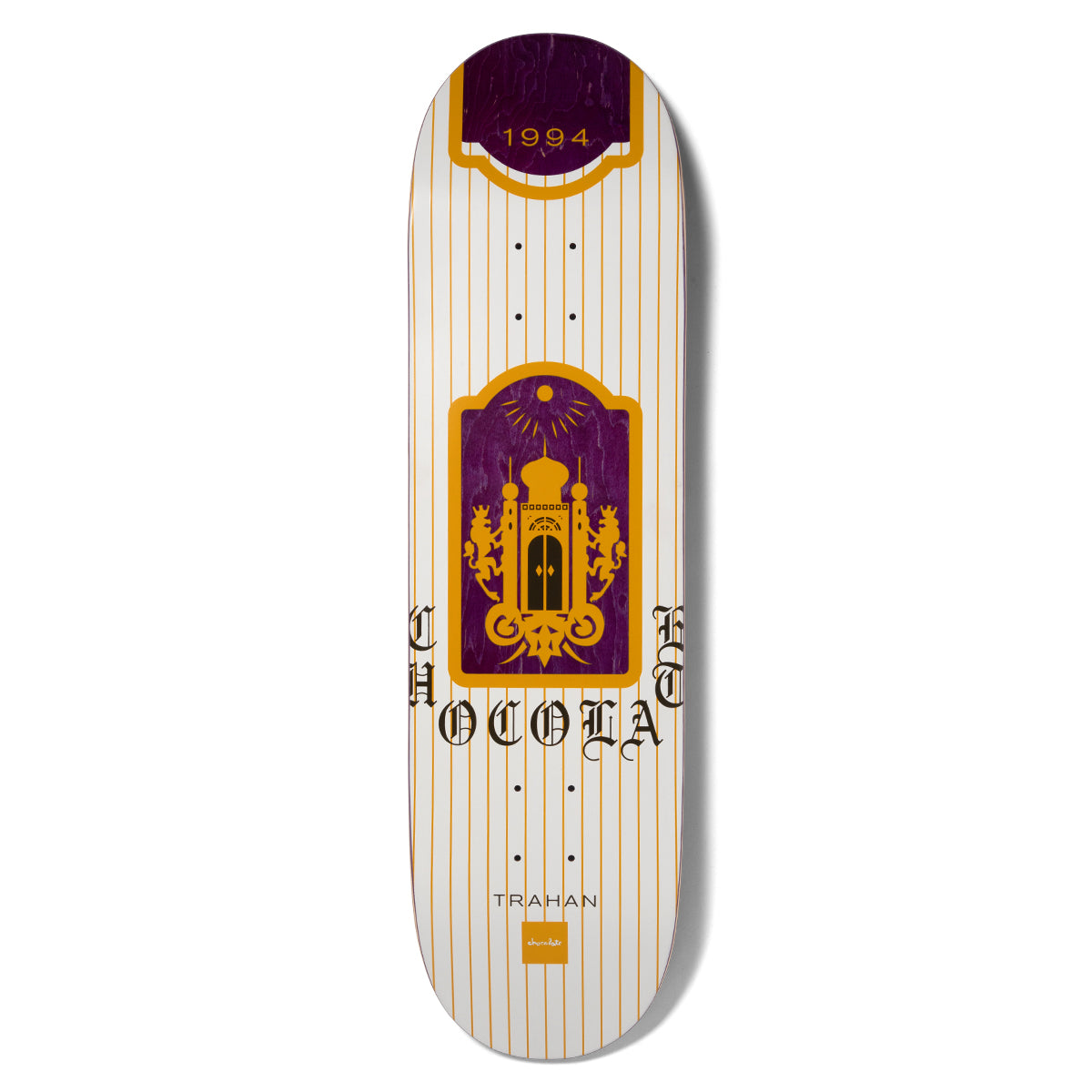 Chocolate Trahan Burn One skateboard deck: White deck with fine orange pinstripes and a purple and orange arched panel showing a domed palace flanked by two lions, with 1994 in a banner at the top and old English Chocolate lettering split around the panel.