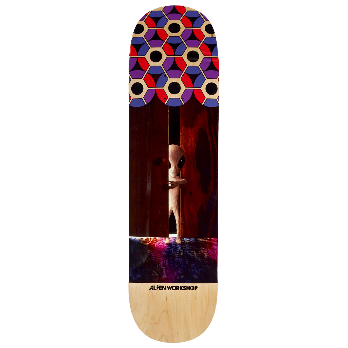 Alien Workshop Visitor Doorway skateboard deck: Photographic scene of a small grey alien peering around a partly open dark wooden door onto a colourful carpet, with a hexagonal pattern of red, purple, blue and cream at the nose and natural maple wood at the tail.