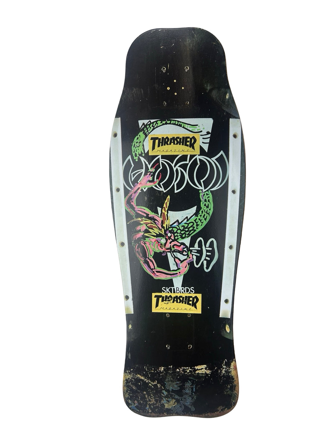 Hosoi Dragon skateboard deck: Worn black old-school shaped deck with a green and pink dragon coiled around Hosoi lettering in white outline, with white side panels and two Thrasher magazine stickers. The tail is badly scuffed.