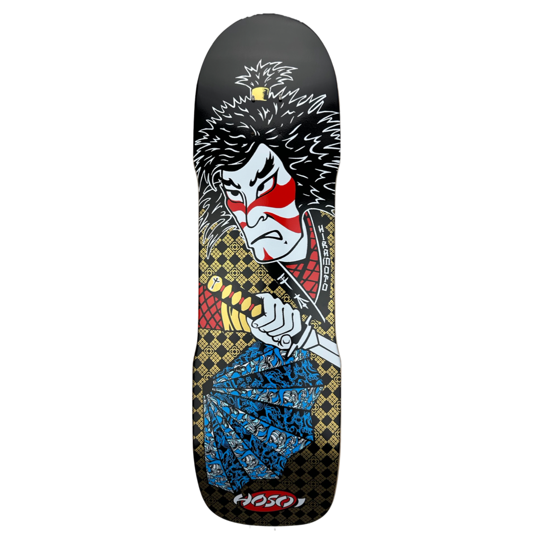 Hosoi Lonny Hiramoto Samurai skateboard deck: A kabuki-style samurai with wild black hair, red face paint and a grim expression grips a sword hilt, with a blue folded fan below, over a gold diamond-lattice pattern on black.