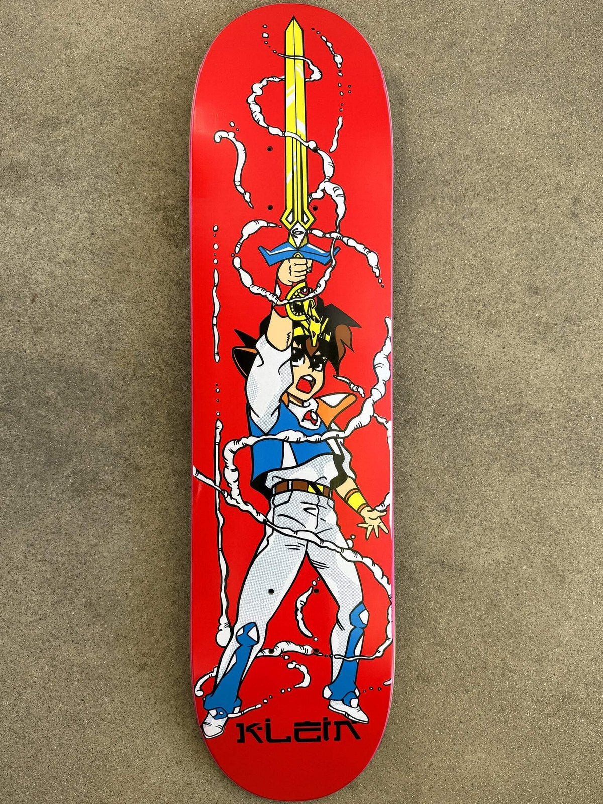 JK Industries Wataru skateboard deck: Anime-style boy in white and blue armour raising a golden sword overhead, with white smoke or wind swirls curling around him, on a flat red deck. Rider name printed at the bottom.