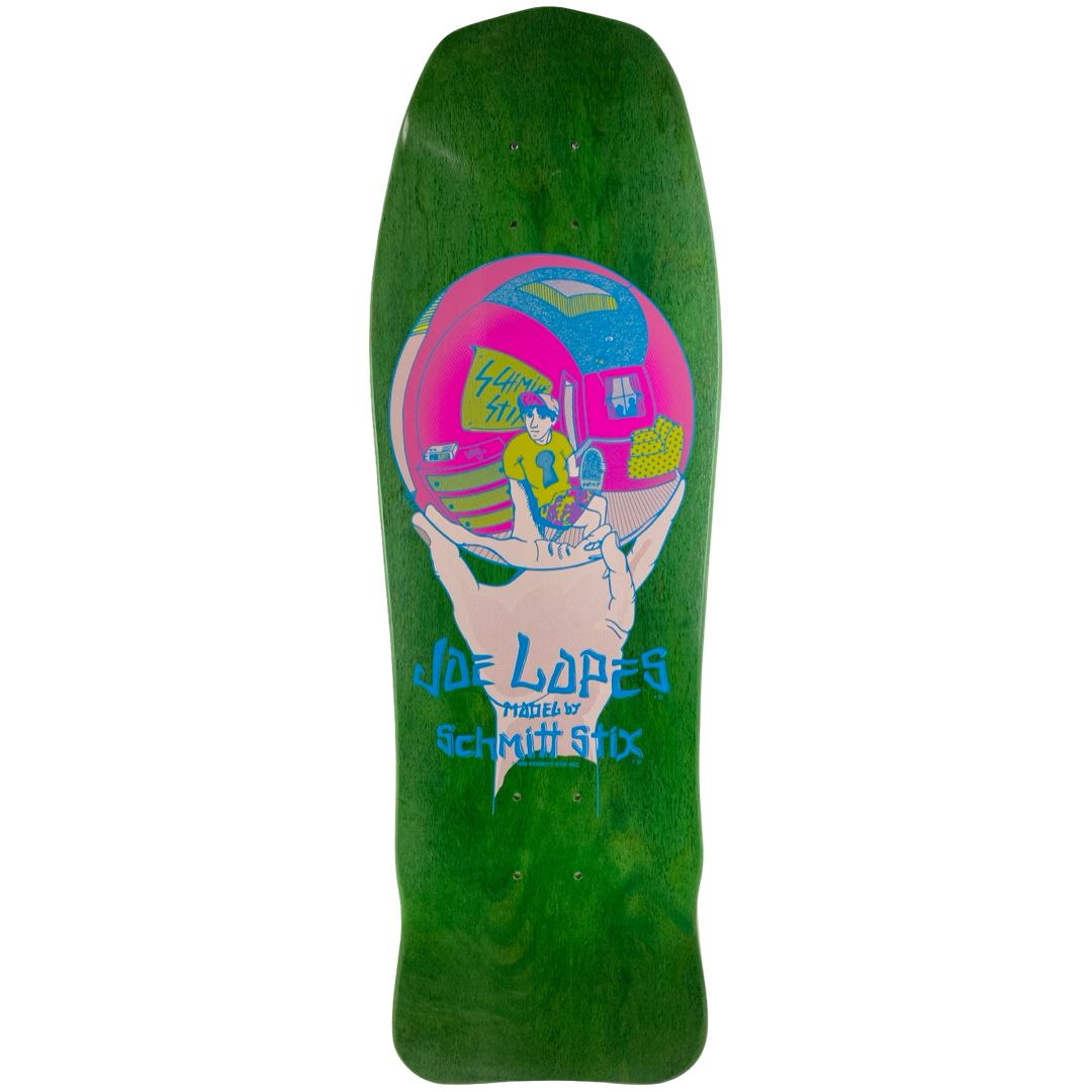 Schmitt Stix Joe Lopes Crystal Ball Modern Concave skateboard deck: A hand holds up a crystal ball in pink and blue, reflecting a young man in sunglasses and a yellow top sitting in a room. Rider name and maker credit in blue lettering beneath, on a green-stained shaped deck.