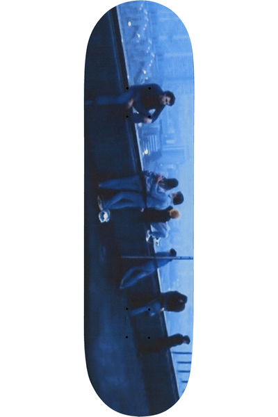 Deathwish Bad Crowd 8.25 skateboard deck: Blue-toned photograph, turned sideways, of a group of people sitting and standing along a ledge or wall above a city at night, with lights in the distance.